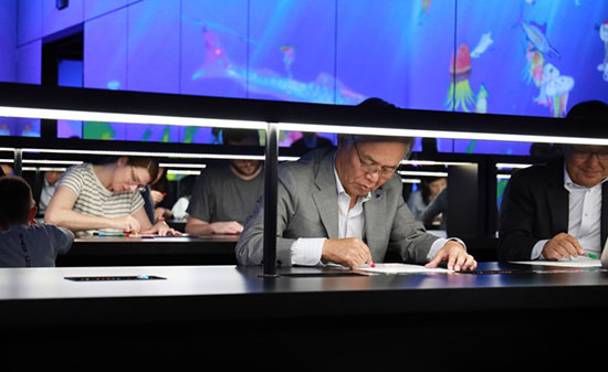 Männer, die ein Bild malen im TeamLab Borderless Customer Experience - Figo GmbH - Shopdesign, Shopkonzepte, Bauleitung, Projektmanagement